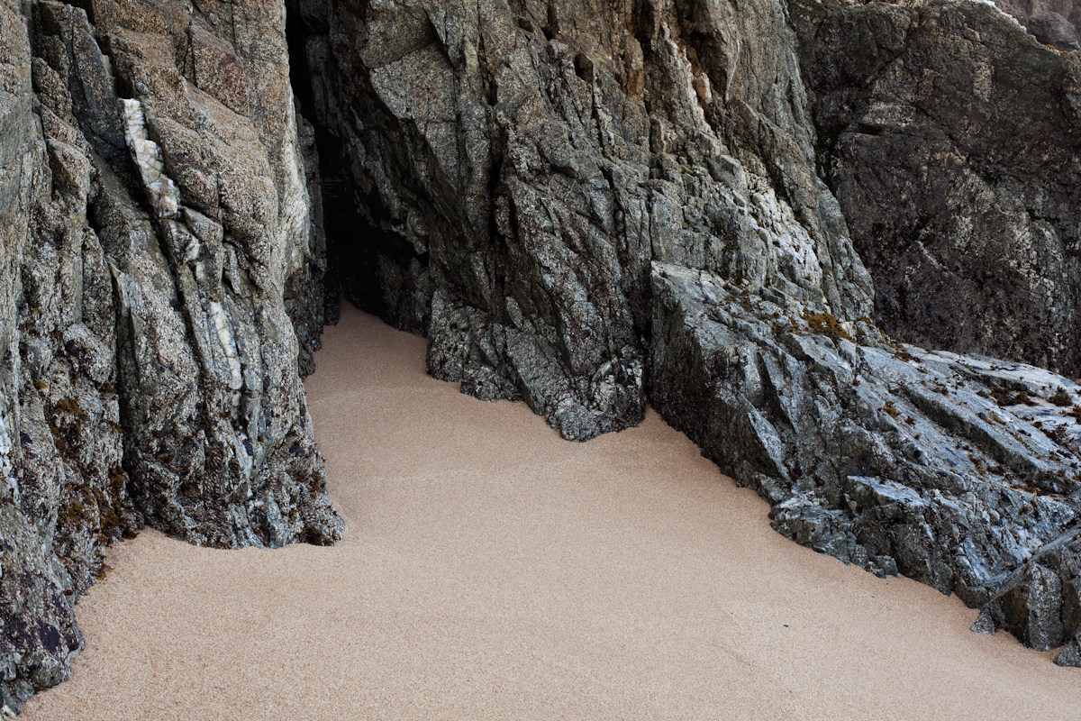 color photograph rocks and sand looks like a large cave